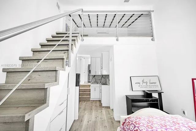 a view of a room with wooden floor