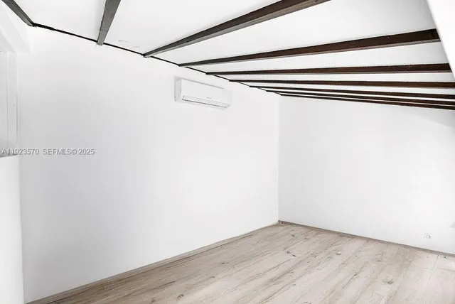 a view of a room with wooden floor