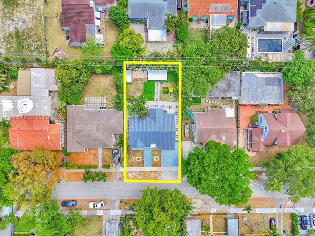 an aerial view of multiple houses with yard