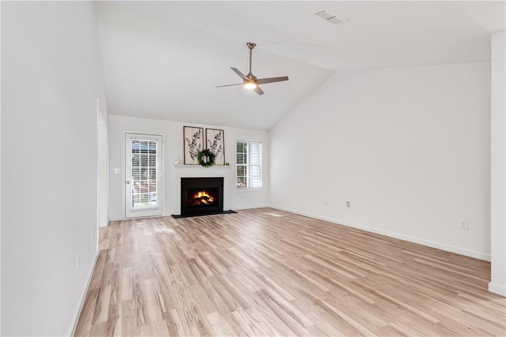 125 Pine Ridge Trace Athens, GA 30605 - Photo 3 of 28 a view of an empty room with wooden floor fireplace and a window
