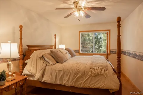 a bed sitting in a bedroom next to a window