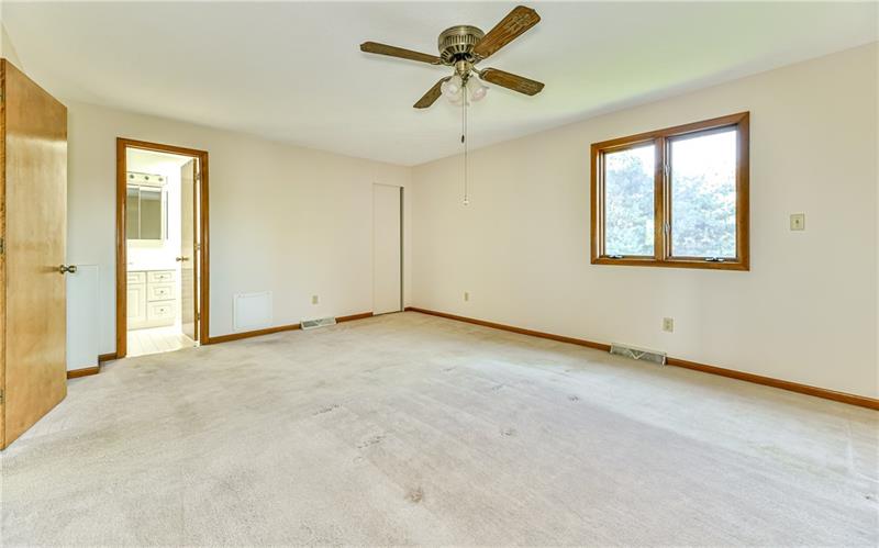 303 Ridgeway Drive Wexford, PA 15090 - Photo 13 of 21 Large master bedroom will easily fit a king sized bed and features walk in closet with pocket door and ceiling fan with overhead lighting.