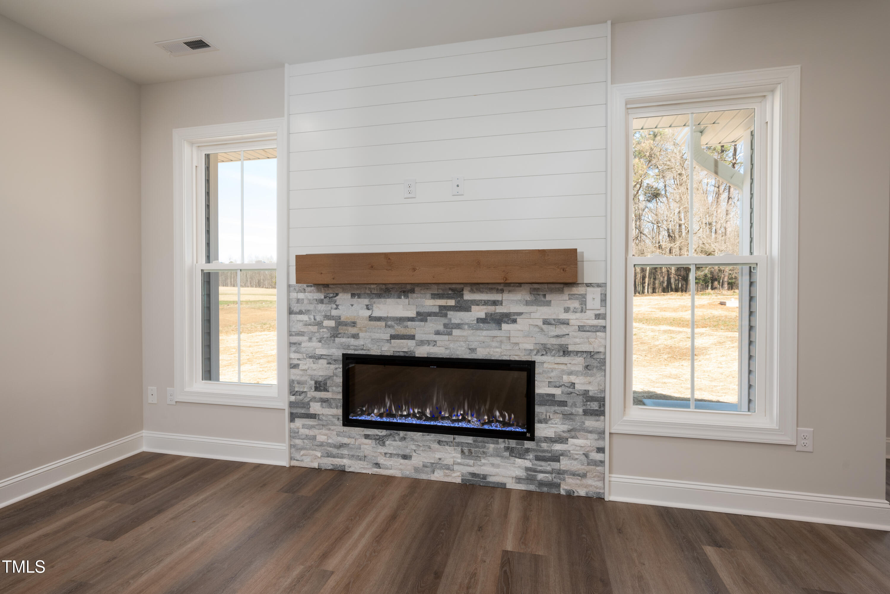 9618 Stallings Road Spring Hope, NC 27882 - Photo 11 of 31 a living room with a fireplace and windows