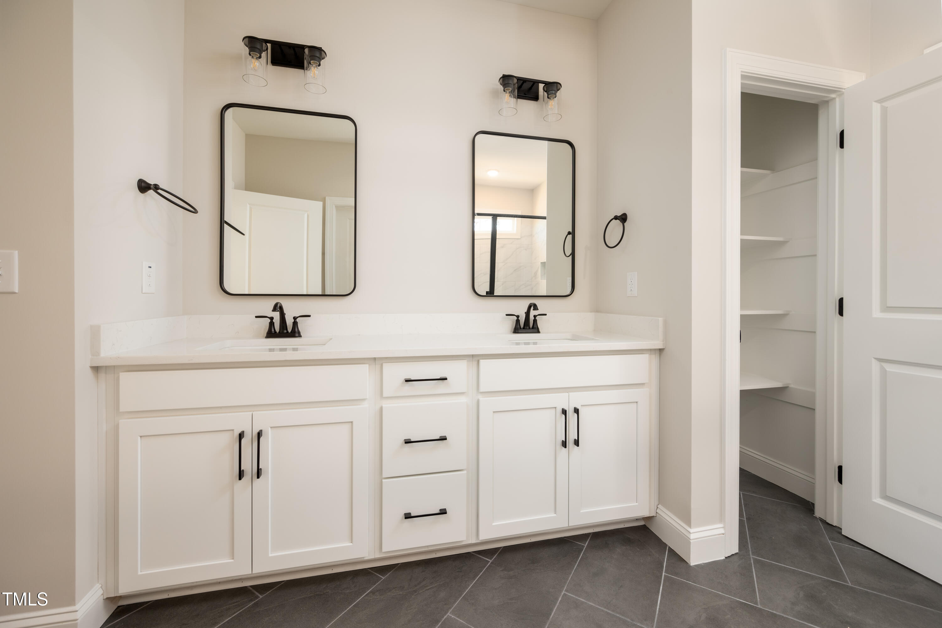 9618 Stallings Road Spring Hope, NC 27882 - Photo 14 of 31 a bathroom with double vanity sinks and a mirror