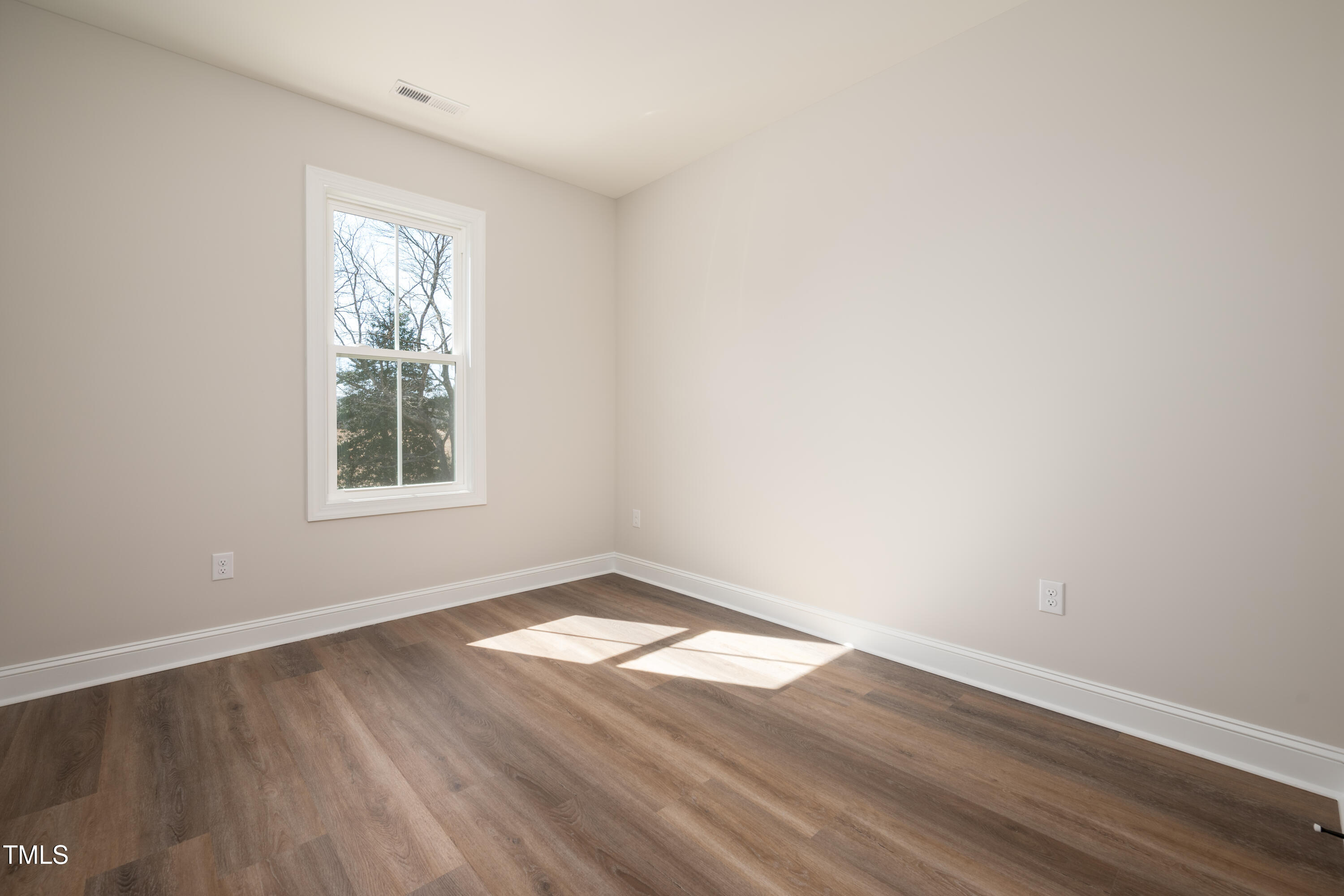9618 Stallings Road Spring Hope, NC 27882 - Photo 23 of 31 an empty room with wooden floor and windows