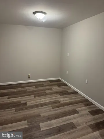 a view of room with wooden floor