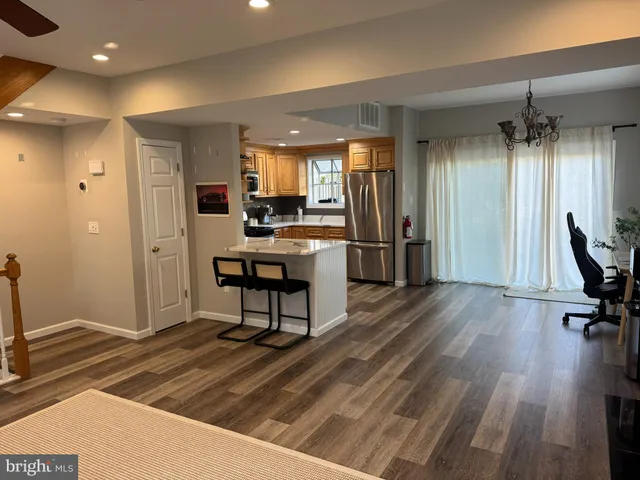 a view of a hallway with wooden floor and furniture