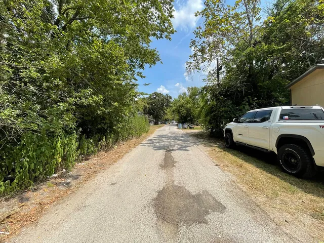 a view of a car parked in back yard of a house