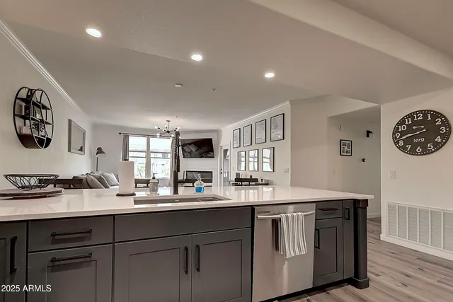 a view of a kitchen with cabinets and wooden floor