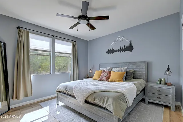 a bedroom with a bed and a painting on the wall