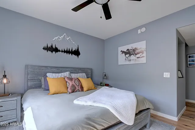 a bedroom with a bed and a large mirror