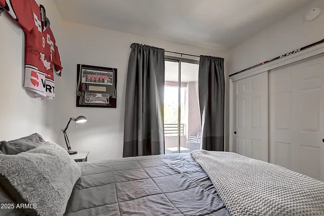 a bedroom with a bed and cabinets