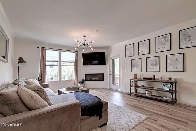 a living room with furniture a fireplace and a flat screen tv