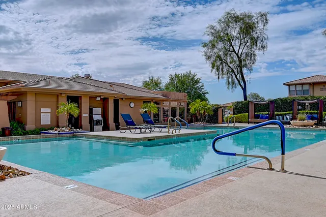a view of a house with swimming pool and sitting area