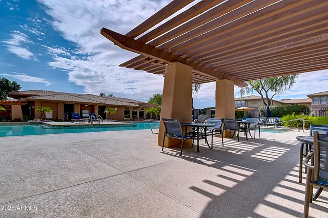 a living room with stainless steel appliances furniture a dining table and chairs