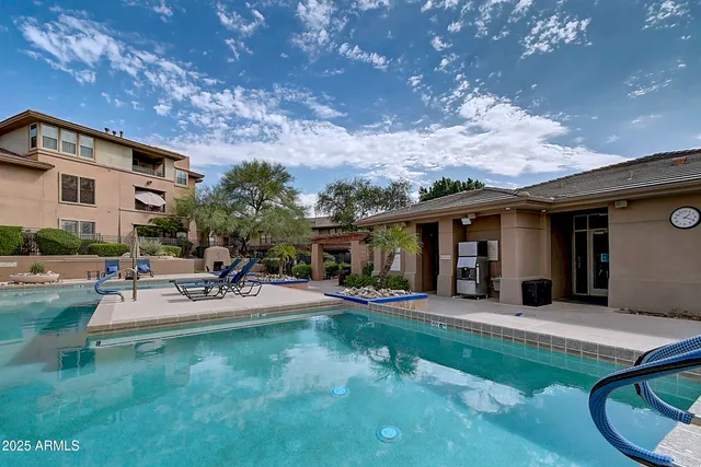 a room with lots of wooden furniture and a chandelier