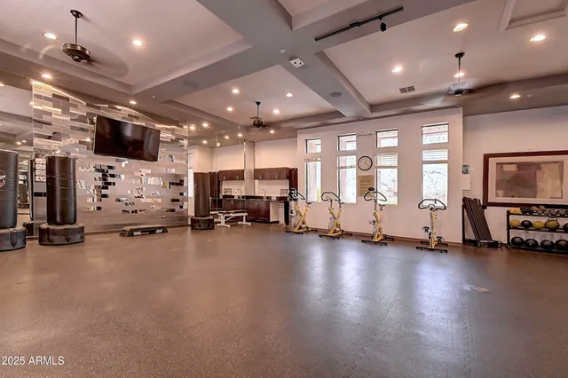 a view of a backyard with table and chairs plants and large trees