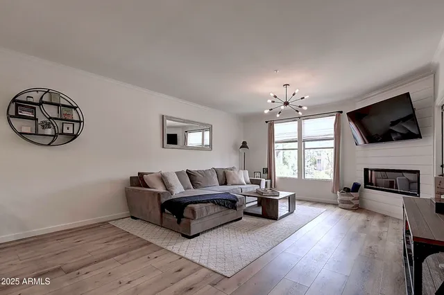 a open dining room with wooden floor and stainless steel appliances