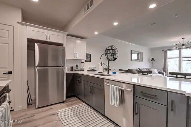 a kitchen with a sink cabinets and window