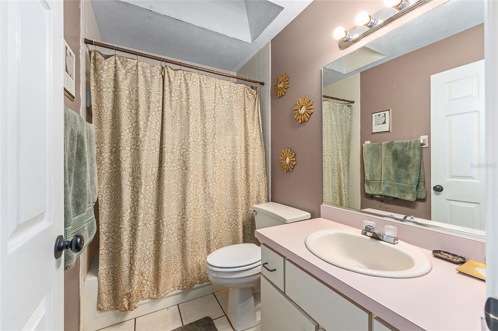 2227 Southwest 80th Avenue Ocala, FL 34481 - Photo 13 of 28 a bathroom with a sink a toilet and shower