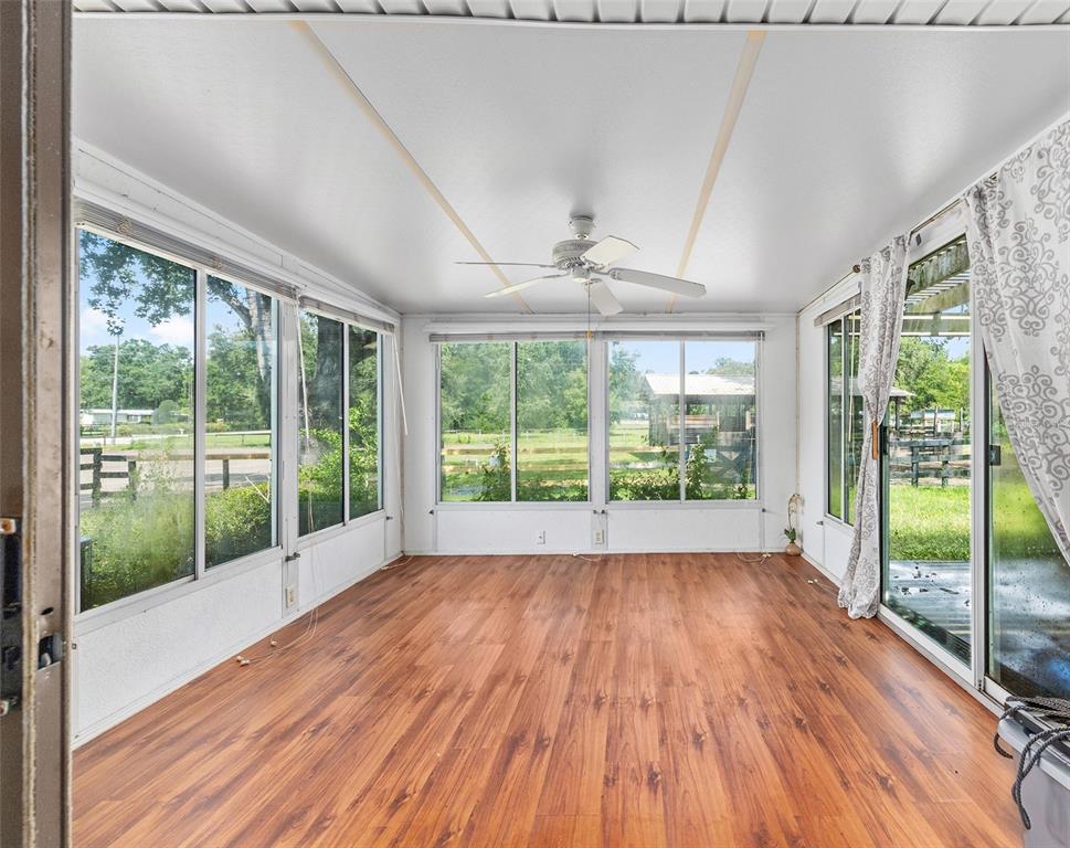 2227 Southwest 80th Avenue Ocala, FL 34481 - Photo 15 of 28 a view of empty room with wooden floor and fan