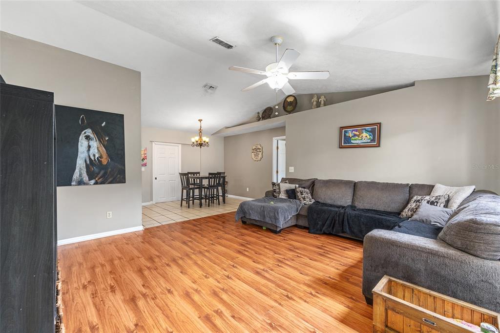 2227 Southwest 80th Avenue Ocala, FL 34481 - Photo 3 of 28 a living room with furniture and a wooden floor