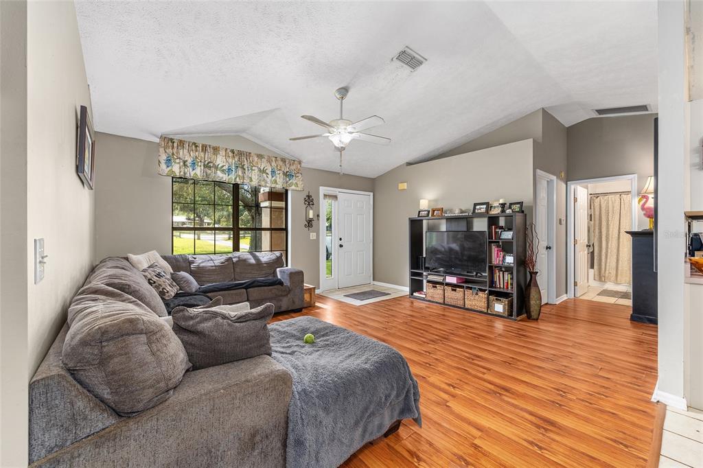 2227 Southwest 80th Avenue Ocala, FL 34481 - Photo 5 of 28 a living room with furniture and a flat screen tv