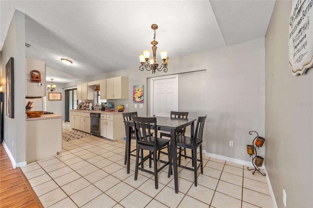2227 Southwest 80th Avenue Ocala, FL 34481 - Photo 6 of 28 a view of a dining room with furniture and chandelier