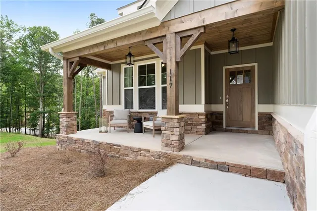 a view of a house with backyard and sitting area