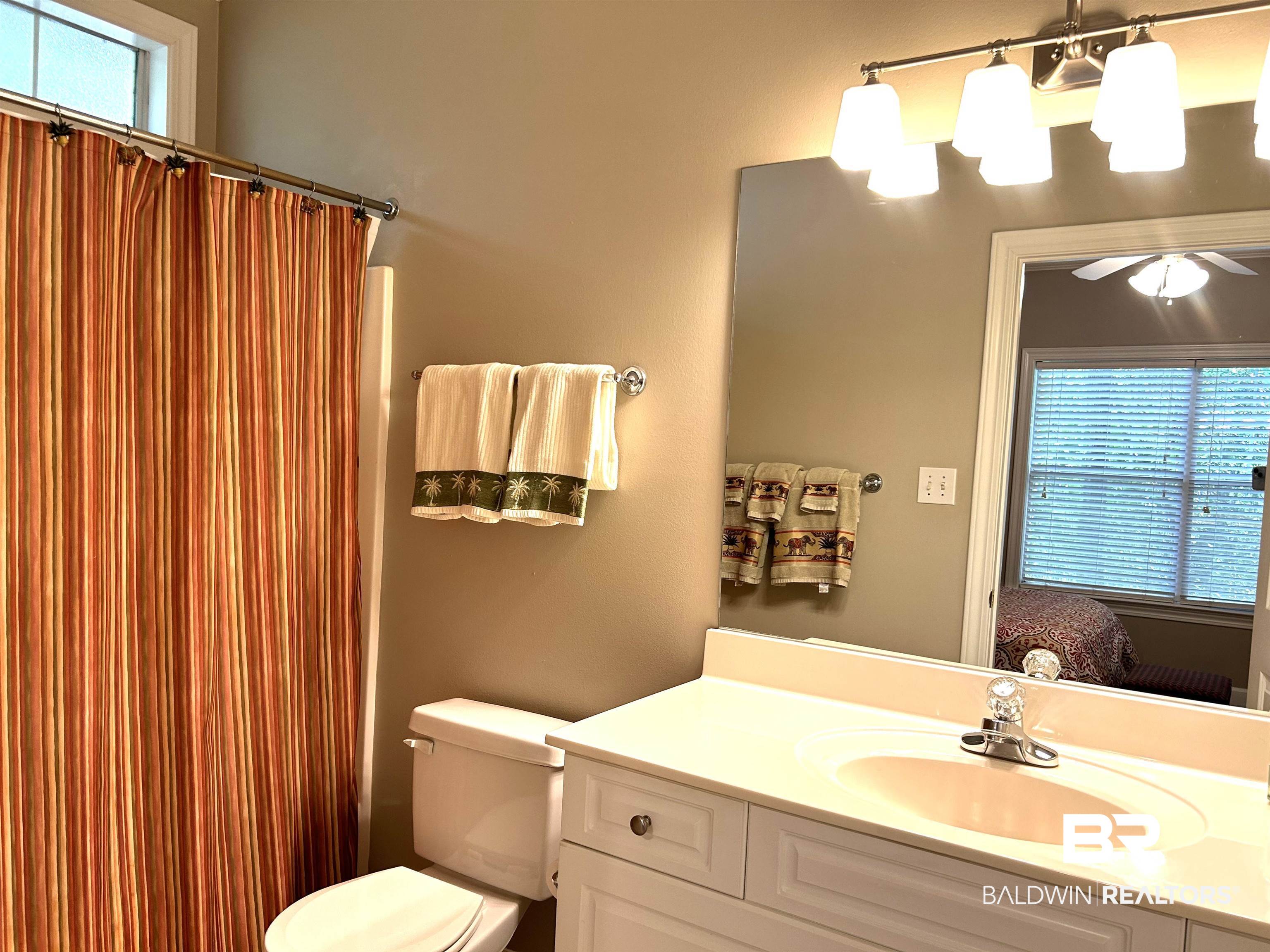 430 West Fort Morgan Road, Unit 404 Gulf Shores, AL 36542 - Photo 19 of 31 Bathroom featuring vanity, toilet, and ceiling fan