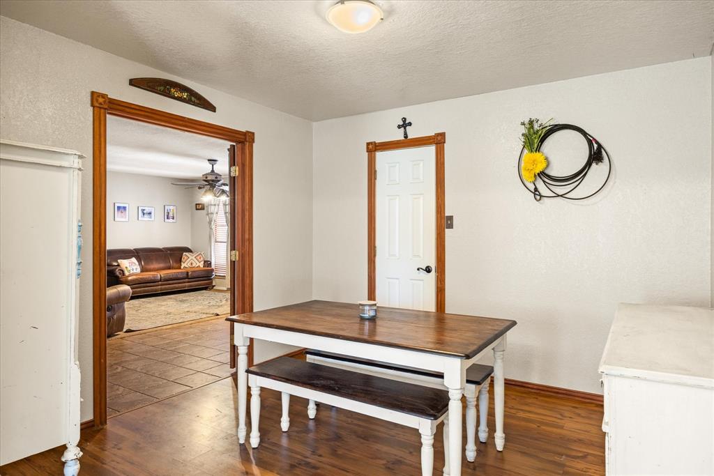 614 Overhill Road Granbury, TX 76048 - Photo 11 of 40 a living room with a wooden floor and a table