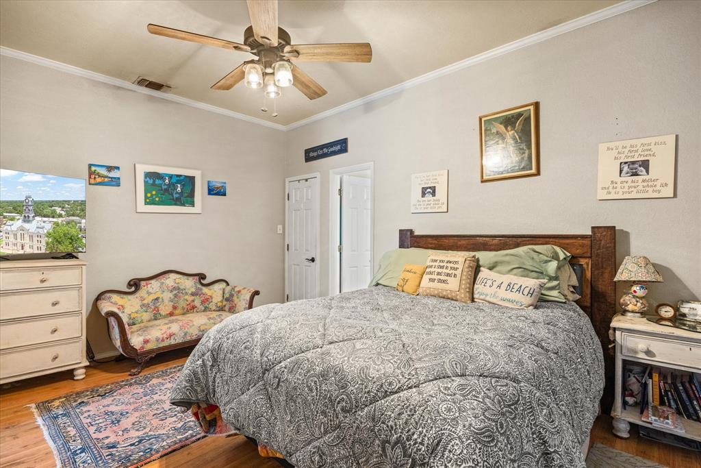 614 Overhill Road Granbury, TX 76048 - Photo 15 of 40 a bedroom with a bed and dresser