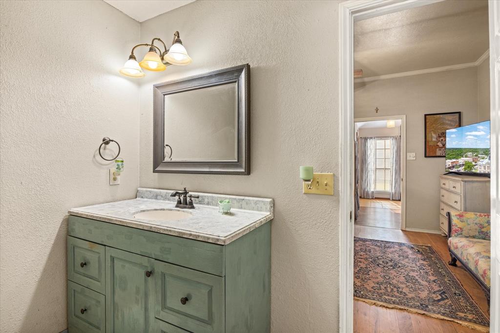614 Overhill Road Granbury, TX 76048 - Photo 17 of 40 a bathroom with a sink and a mirror