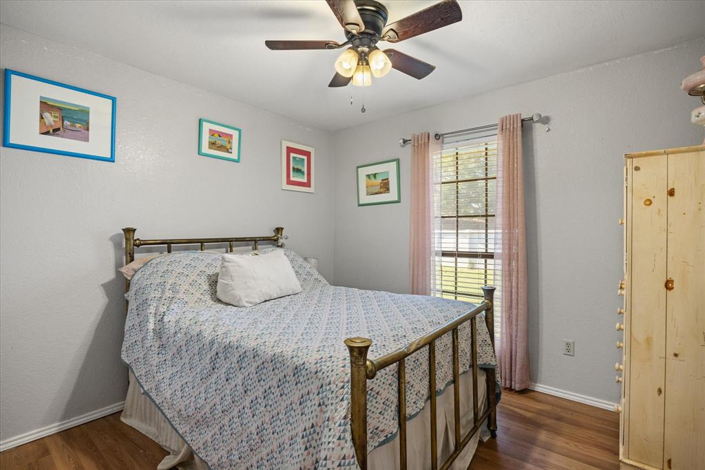 614 Overhill Road Granbury, TX 76048 - Photo 25 of 40 a bedroom with a bed and a window