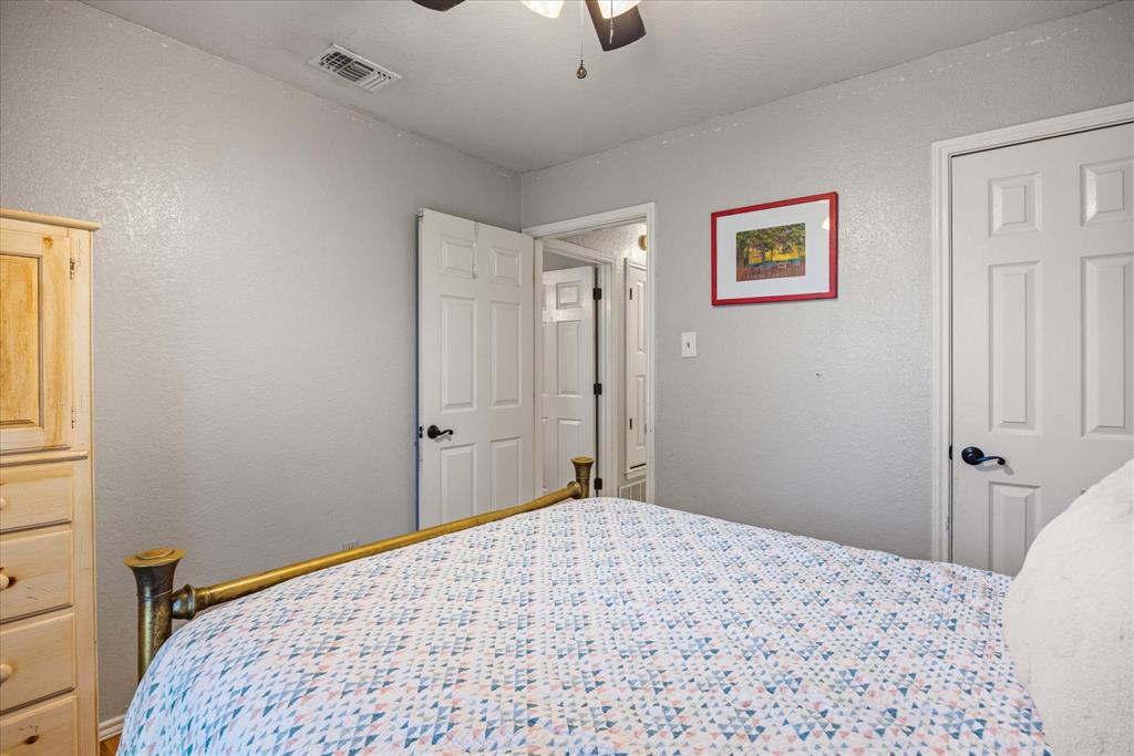 614 Overhill Road Granbury, TX 76048 - Photo 26 of 40 a bedroom with a bed and a window