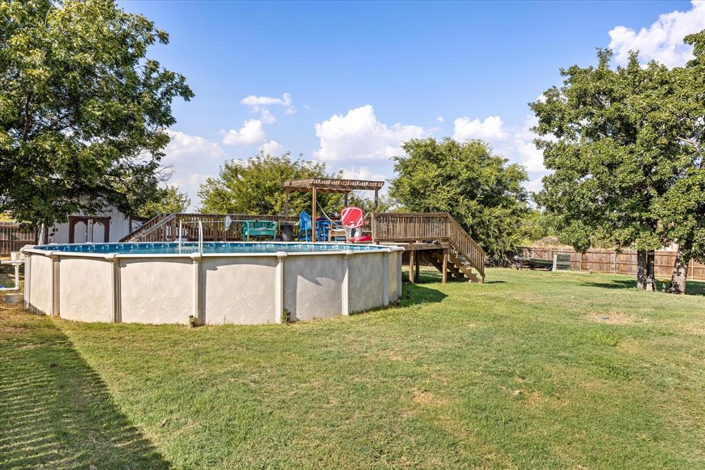 614 Overhill Road Granbury, TX 76048 - Photo 30 of 40 a view of a swimming pool with a yard