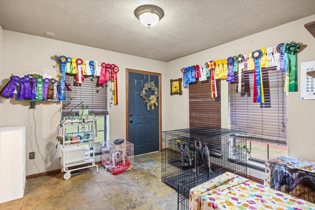 614 Overhill Road Granbury, TX 76048 - Photo 6 of 40 a bedroom with furniture and a bathtub