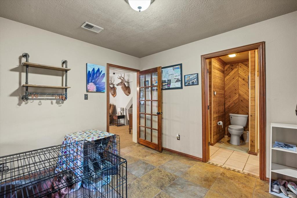 614 Overhill Road Granbury, TX 76048 - Photo 7 of 40 a view of a hallway with workspace and a window