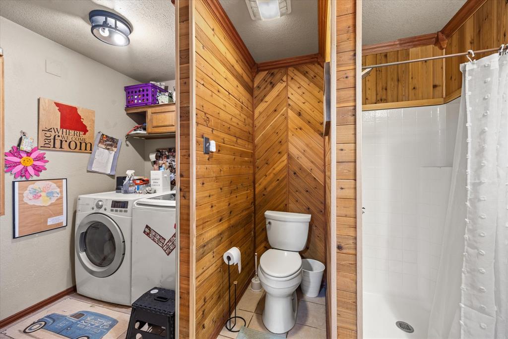 614 Overhill Road Granbury, TX 76048 - Photo 8 of 40 a view of a storage & utility room with dryer and washer