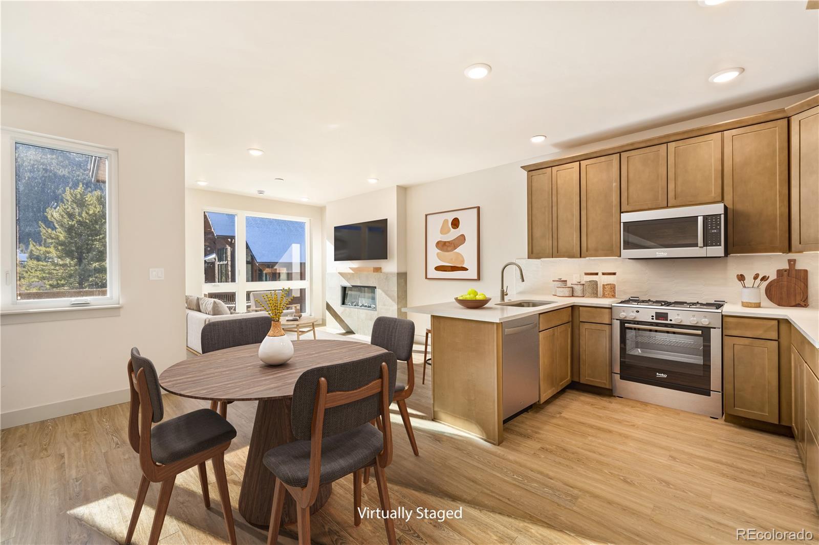 a large kitchen with kitchen island granite countertop wooden floors and wooden cabinets