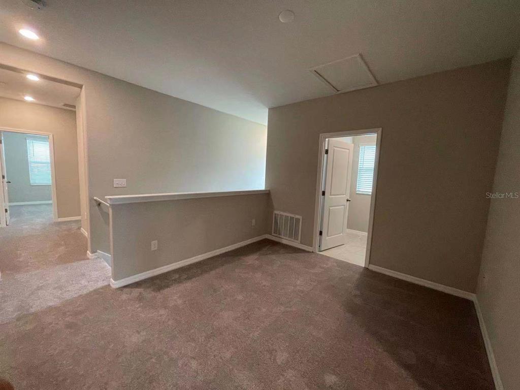 31993 Blue Passing Loop Wesley Chapel, FL 33545 - Photo 11 of 17 an empty room with closet and windows