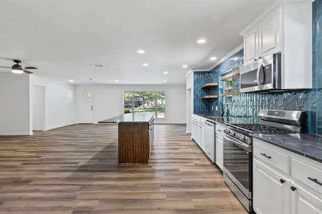 a view of kitchen and kitchen with stainless steel appliances granite countertop cabinets