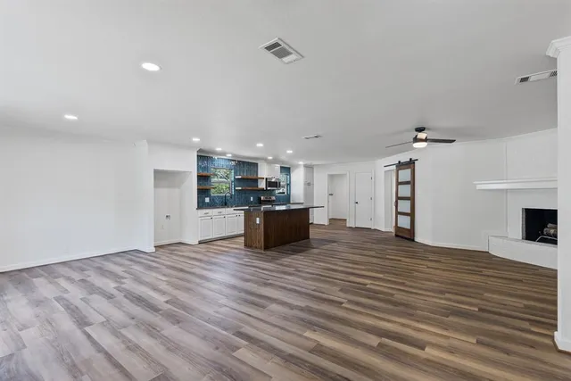 a view of a kitchen with a sink and a refrigerator