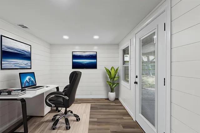 a work room with furniture and wooden floor