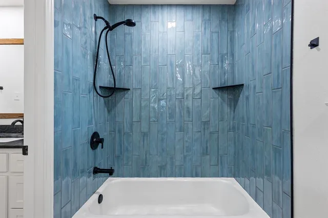 a bathroom with a shower and a bath tub