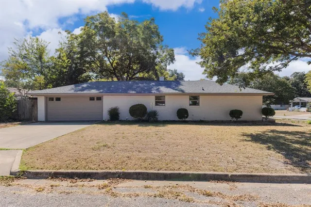 a front view of house with trees