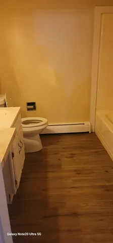 a view of washer and dryer with wooden floor