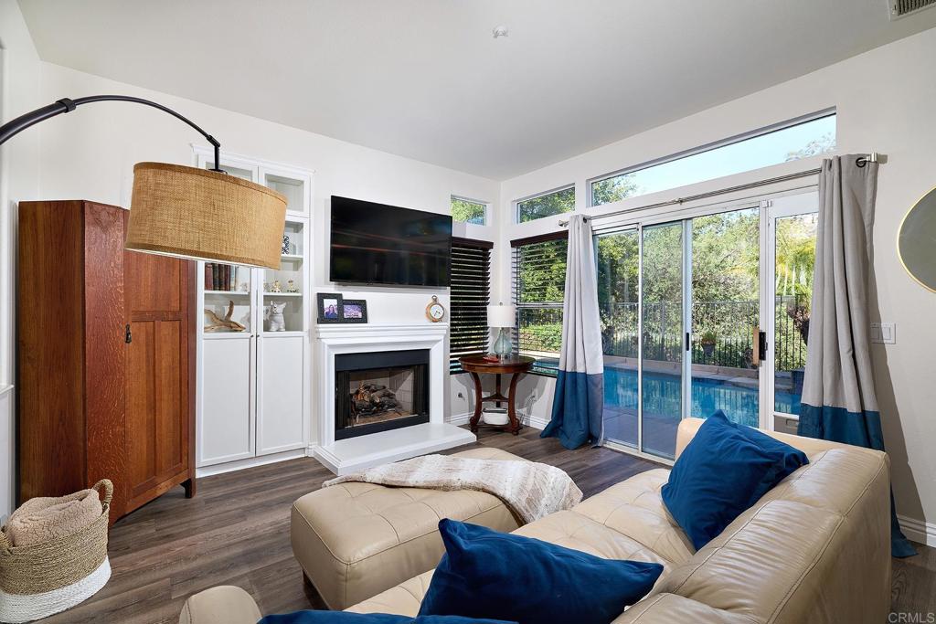 2414 Fallbrook Place Escondido, CA 92027 - Photo 29 of 63 a living room with furniture a fireplace and a flat screen tv