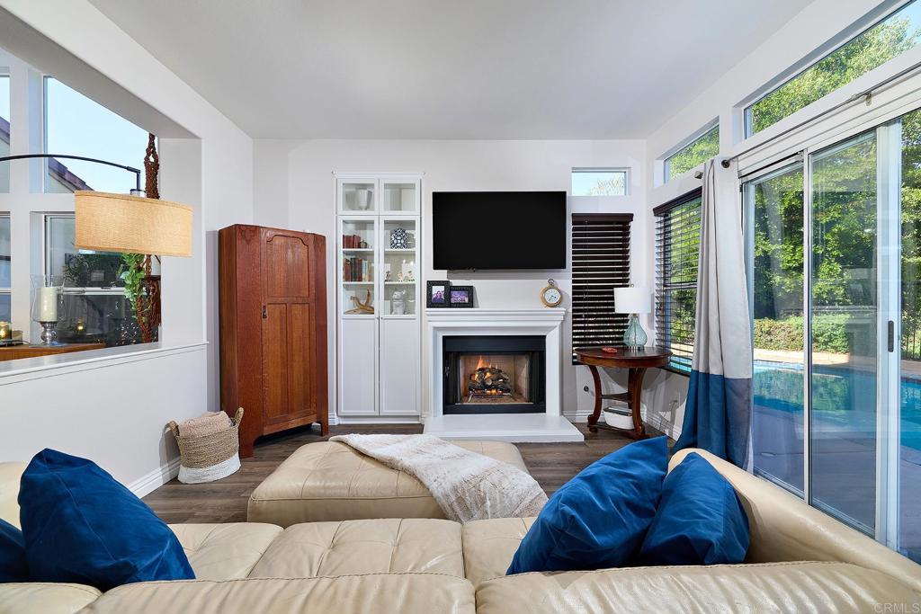 2414 Fallbrook Place Escondido, CA 92027 - Photo 30 of 63 a living room with furniture a fireplace and a flat screen tv
