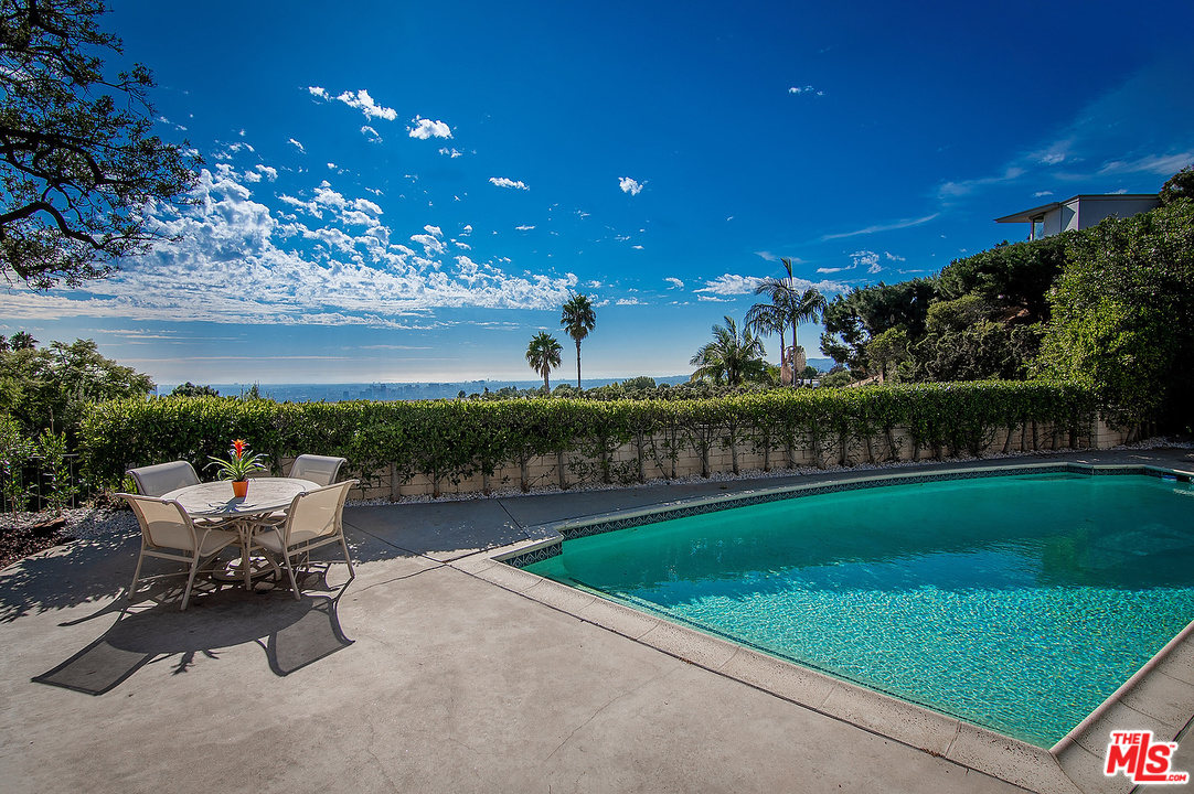 534 Chalette Drive Beverly Hills, CA 90210 - Photo 1 of 1 a view of a garden with lawn chairs and a fire pit